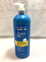 Matte blue 1L pump bottle of Marc Anthony Argan Oil of Morocco Extra Hydrating Conditioner, front view