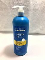 Front view of blue pump bottle with Marc Anthony Nourishing Argan Oil of Morocco label showing product name and volume (1L).