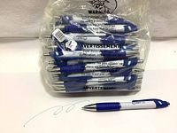 Pack of 50 blue ink ballpoint pens in clear plastic packaging showing the pens stacked inside with visible blue grips and silver accents.