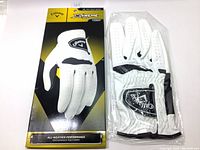 Packaging and the golf glove in protective plastic with visible Callaway branding and white color.
