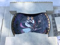 Collectors plate in original foam packaging, showing detailed artwork of a man and woman in traditional clothing and a deer, with accompanying foreign language certificate.