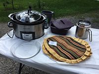 Image showing entire lot including Crock-Pot slow cooker, silicone dish with lid, glass pie plate, metallic coffee pot, and fabric pie cover.