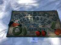 Full view of the rectangular handmade wall hanger with embroidered text and vegetable appliques.