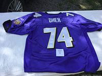 Back of Baltimore Ravens Michael Oher football jersey showing player name OHER and number 74 in white and gold on purple, with Ravens patches on sleeves