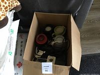 Box filled with multiple Scentsy warmers and electric cords, viewed from above.