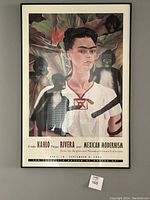 Full-front view of framed poster hanging on wall