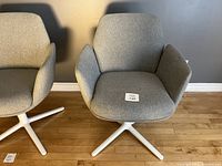 Two Haworth Poppy chairs side by side against a grey wall on hardwood floor