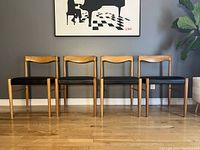 Front view of four chairs in a row against grey wall