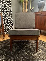 Front view of teak slipper chair with grey cushions