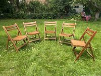 All five chairs arranged in a semi-circle on grass