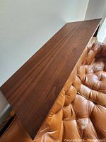 Top view of the rectangular teak shelf showing wood grain and finish.