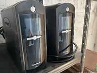 Front view of two CyberPower 1500VA UPS units side by side showing their power buttons and front display panels