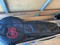 Full view of the black cloth gig bag laid flat, showing its overall shape and condition.