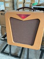 Front view of tan vinyl-covered amplifier and brown grille cloth
