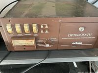 Front and top view of brown rack-mount electronics unit