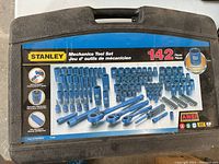 Closed case showing label of Stanley Mechanics Tool Set with 142 pieces and product features