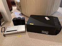 Full setup showing three small speakers, CD player, and large Bose subwoofer.