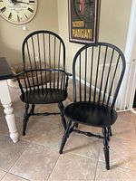 Pair of chairs showing one captains chair with arms and one side chair front view
