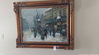 Frontal view of the framed oil painting depicting a snowy city street scene with pedestrians and buildings.