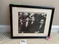 Framed signed Godfather photograph leaning against a wall, showing full frame and mat with signature.