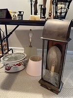 Full view of Hamilton Beach crock pot, table lamp with glass base and shade, and heavy metal wall light.