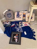 Full lot including 4 Super Bowl XXI seat cushions, Giants throw, t-shirt, pennant and framed photo of Phil Simms.