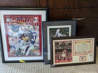 Framed Sports Illustrated cover showing Eli Manning's football catch against New England Patriots. Black frame with white matting.