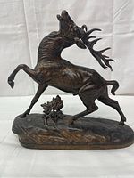 Front view showing rearing stag and base foliage