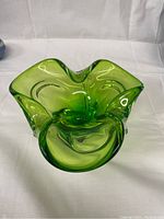 Front-facing photo showing smooth apple green color and organic flowing shape of Murano glass bowl