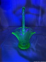 Uranium glass basket glowing green under black light showing its fluorescent properties