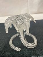 Side angle showing curved stem and petal-like top of bud vase