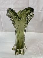 Front view of vintage heavy olive green sommerso art glass vase showing squared petal top and clear side glass folds