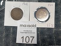 Two Canadian pennies from 1911 and 1912 in 2x2 holders with staples, visible markings and grading for 1911 coin.