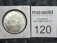 Single 1966 Canadian silver dollar coin in a cardboard holder with visible date and design.