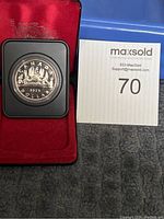 1975 Canadian silver dollar coin in a red display box with velvet lining.