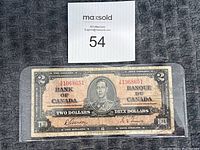 Front side of the 1937 Canadian two dollar bill with serial number and King George VI portrait visible.
