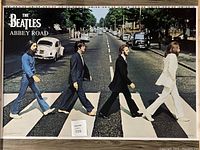 Full view of The Beatles Abbey Road poster with visible film edges showing uncut condition.