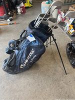 Golf stand-up bag with clubs set inside, navy blue, labelled Sunrtec.