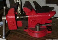 Front and side view of Fuller red bench vise showing brand name, jaw size (3.5 inches), and swivel base.