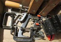 Several metal C-clamps, smaller spring clamps, and Jorgensen wood clamp handles visible in the box.