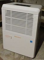 Front view of the Ocean Breeze white dehumidifier showing vented panel and brand label.