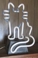 Neon cat light off, showing white neon tubing shape on black base