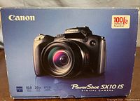 Original blue Canon PowerShot SX10 IS box showing product image and branding