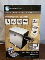 Front of product box showing the converter and types of media it converts (negatives, slides, photos, business cards).