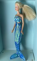 Side profile of Mermaid Barbie wearing the blue scale patterned mermaid tail and strapless dress