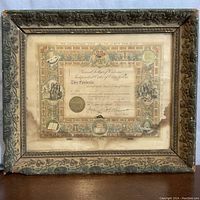 Front view of framed 1905 Odd Fellows certificate showing full frame and certificate with water stains.
