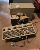 Overall lot: keyboard, printer, computer tower, speakers and mouse on carpeted floor