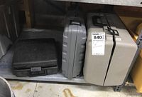 Three closed carrying cases on a warehouse shelf, corresponding to the joiner and two drills