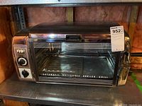 Full front view of the vintage Kenmore rotisserie oven showing overall condition and placement.