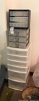 Full view of three stacked plastic storage drawer units of various sizes.